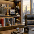 Modern office desk with cross on a bookshelf witrh pictures, mug, and cityscape view