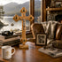 Wooden crucifix on a table with books and a mug, window view of a lake and mountains.