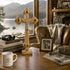 Wooden crucifix on a table with books and a mug, window view of a lake and mountains.