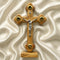 Wooden cross with a figure of Jesus on a beige fabric background