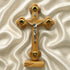 Wooden cross with a figure of Jesus on a beige fabric background