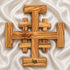 Top view of a large olive wood Crusader Cross on white satin cloth