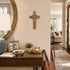 Home interior with a wooden desk, mirror, and cross on the wall.