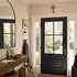 Entryway with a dark wooden door, coat rack, and mirror.