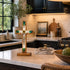 Decorative cross on a kitchen counter with a homey background