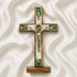 Wooden cross with a figurine of Jesus on a white fabric background