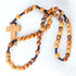 Pack-shot of a Latin-style cross on a handcrafted olive wood rosary with black rope on a white background.