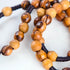 Close-up image of a handcrafted olive wood rosary.