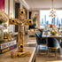 Wooden cross with Jesus figure on a table in a modern living room.