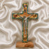 Small latin standing cross with crucifix, mother of pearl inlay and Four Elements, on a white cloth.