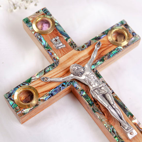 Latin standing cross with crucifix, mother of pearl inlay and Four Elements, laid on white background.