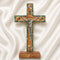 Wooden cross with a figurine of Jesus on a white fabric background