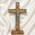 Wooden cross with a figurine of Jesus on a white fabric background