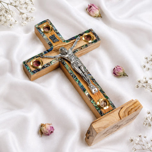 Small latin standing cross with crucifix, mother of pearl inlay and Four Elements, on white background.