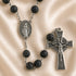 A black lava stone rosary with a silver-tone Miraculous Medal centerpiece and a matching crucifix pendant.