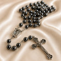 Hematite bead rosary with oval Our Lady of Lourdes medal and metal crucifix centerpiece