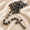 Hematite bead rosary with oval Our Lady of Lourdes medal and metal crucifix centerpiece