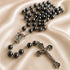 Hematite bead rosary with oval Our Lady of Lourdes medal and metal crucifix centerpiece