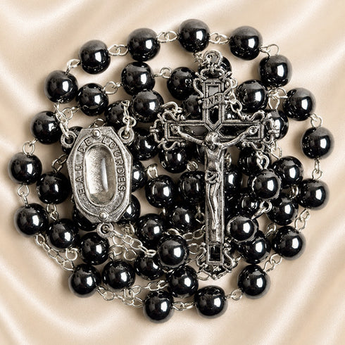 Hematite bead rosary with oval devotional medal and detailed metal crucifix, dark beads