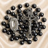 Hematite bead rosary with oval devotional medal and detailed metal crucifix, dark beads