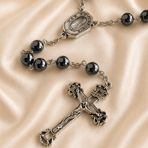 Hematite bead rosary close-up of medal connector and silver-toned crucifix