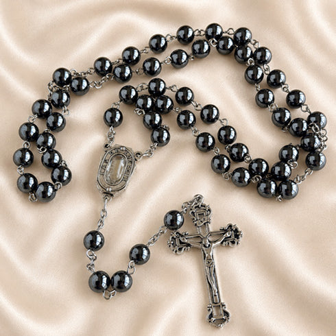 Hematite bead rosary with dark bead strands, oval medal, and crucifix pendant
