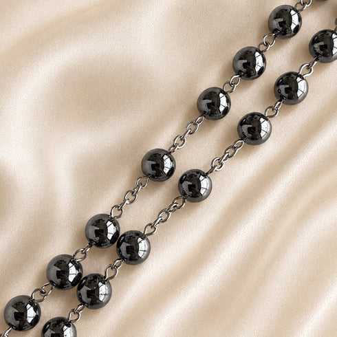 Hematite bead rosary with dark round beads and silver-toned chain links, crucifix end