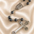 Hematite bead rosary close-up of oval Our Lady medal and linked dark beads