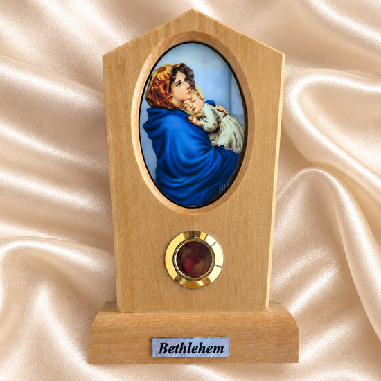 Madonna of the Streets olive wood plaque with natural grain and bark edge on a neutral background