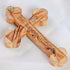 Zoomed image of the back of a handmade budded olive wood cross with Stations of Cross and "Jerusalem" written, placed on a white background.