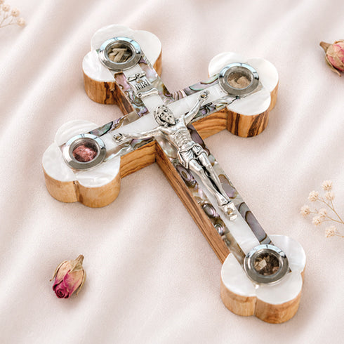 Handmade Eastern cross made of rich olive wood, detailed with white mother of pearl design, silver crucifix, and the four sacred elements from the Holy Land.