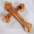 Image of the back of a full size handcrafted budded olive wood cross, placed on a white background.
