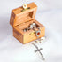 Image of a Mother of Pearl rosary with Holy Soil centrepiece and crucifix placed inside an olive wood box on a white background.