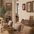 Dining room with a wooden table, chairs, and decorative items on the wall.