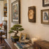 Nestled corner of a room with a bonsai tree, books, and decorative items on a table.