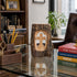 Decorative wooden cross on a desk with books and office supplies