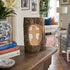 Wooden log with a cutout cross on a wooden surface in a living room.