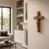 Wooden cross with Jesus figure on a wall in a living room setting
