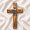 A handcrafted olive wood communion cross with a metal emblem of a praying boy on it.