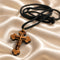 Olive wood cross pendant necklace detail: black cord and gold-tone bail