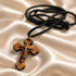 Olive wood cross pendant necklace detail: black cord and gold-tone bail