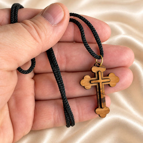 Olive wood cross pendant necklace with black braided cord, gold-tone bail