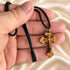 Olive wood cross pendant necklace with black braided cord, gold-tone bail