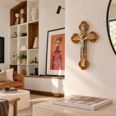 Close product view of an olive wood budded crucifix with abalone inlay