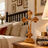 Budded olive wood standing crucifix on display in a bedroom