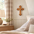 Bethlehem olive wood budded wall cross hanging in a bedroom