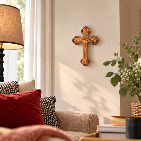Bethlehem olive wood budded wall cross displayed in a living room
