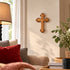 Bethlehem olive wood budded wall cross displayed in a living room