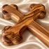 Close-up of a Bethlehem olive wood budded wall cross and its natural wood grain