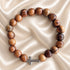 Olive wood rosary-style bead bracelet with metal cross clasp